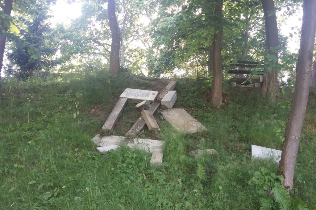 Zdewastowany i porzucony nagrobek na miejskim cmentarzu